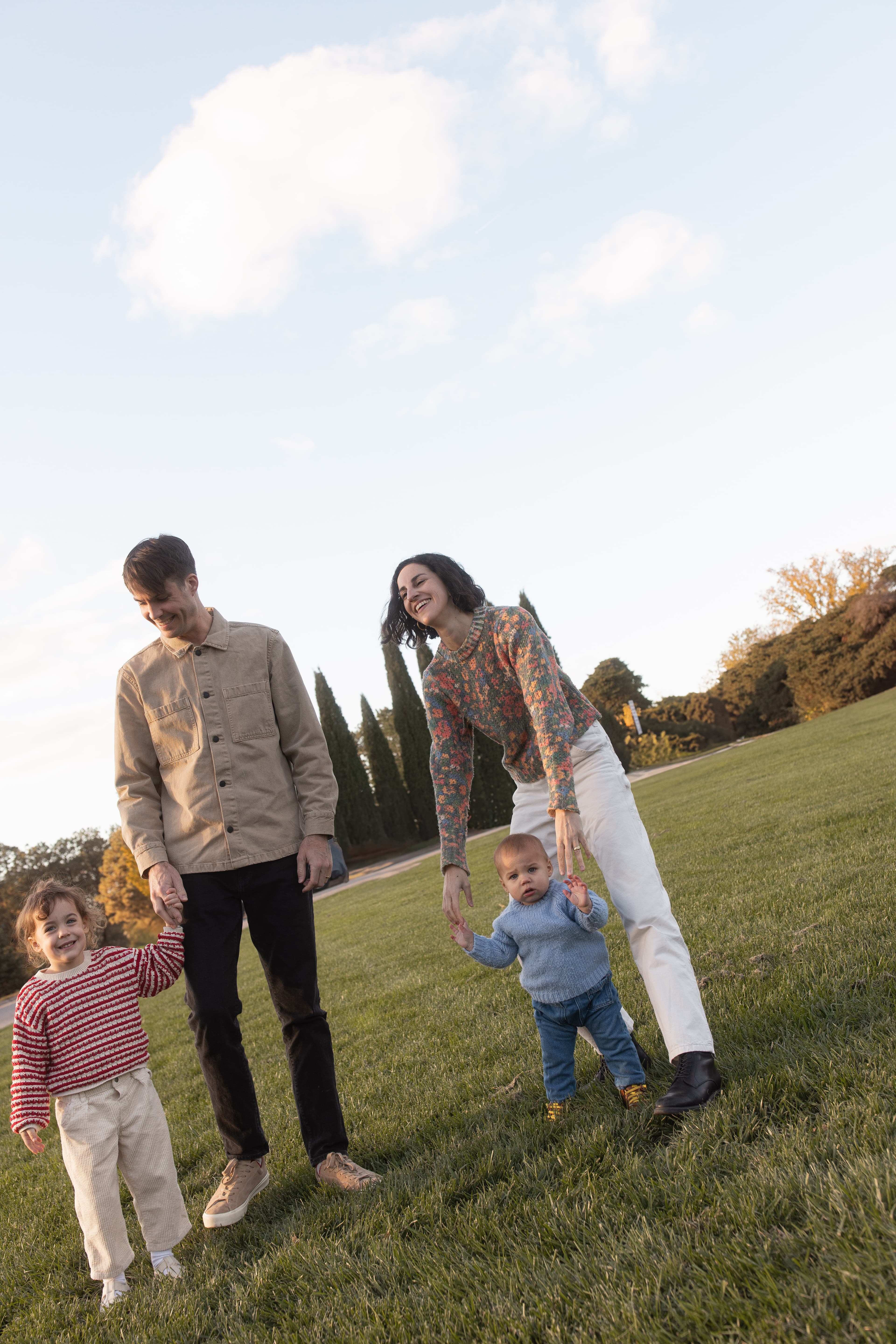Family walking together on green hill