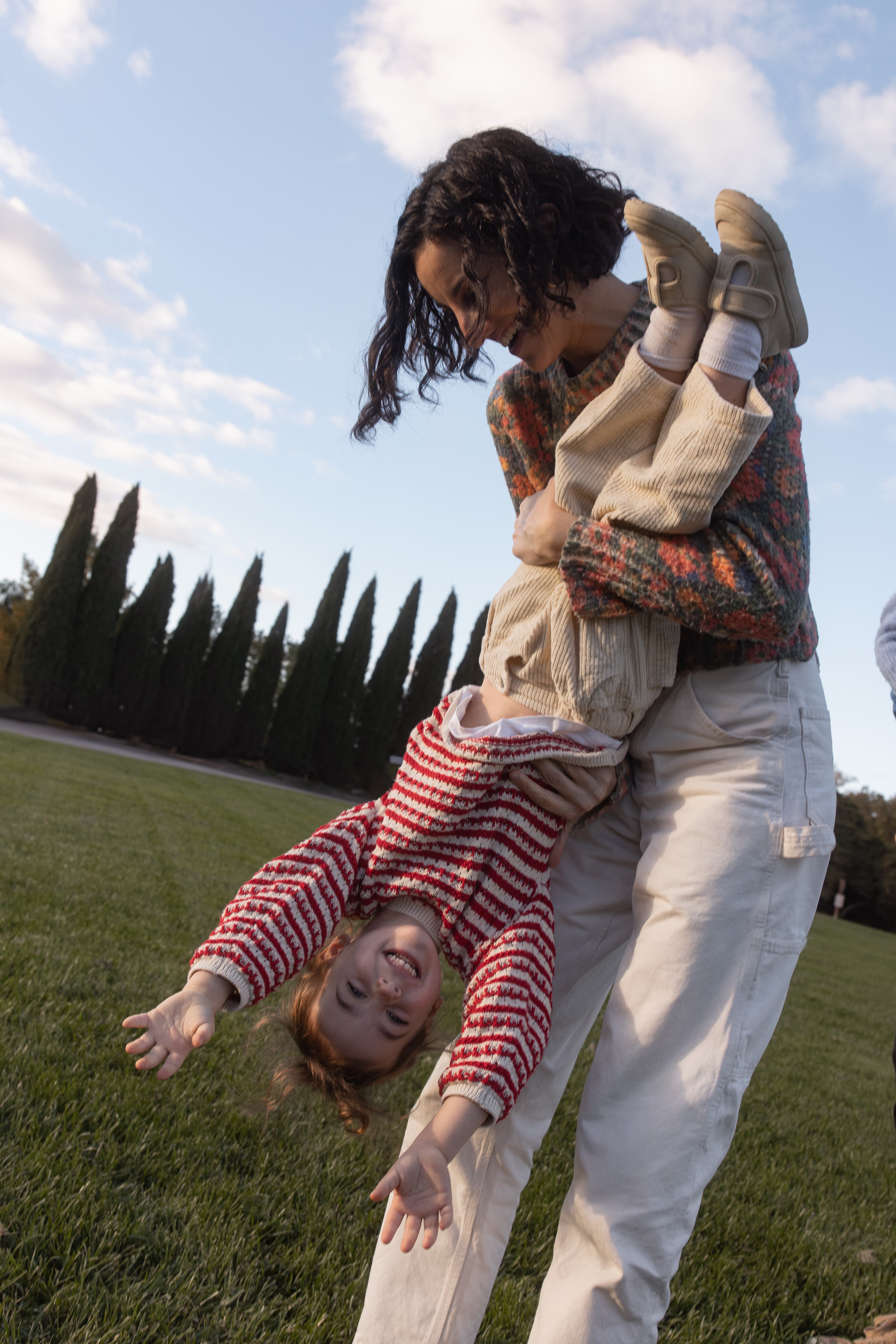 Mother playing with daughter upside down